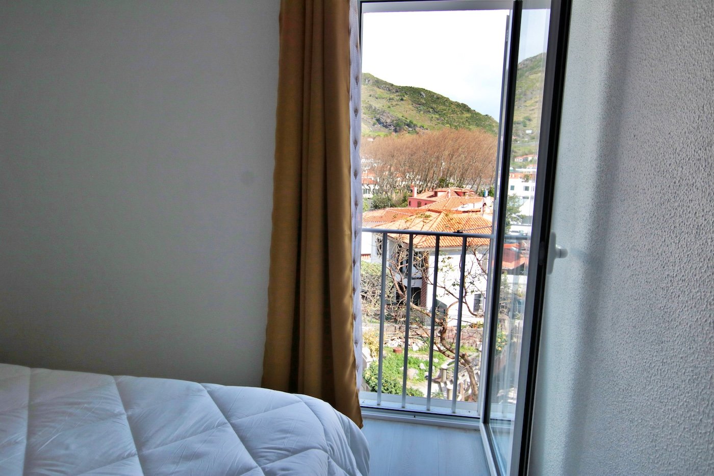 Bedroom window with view of property on the other side of the road