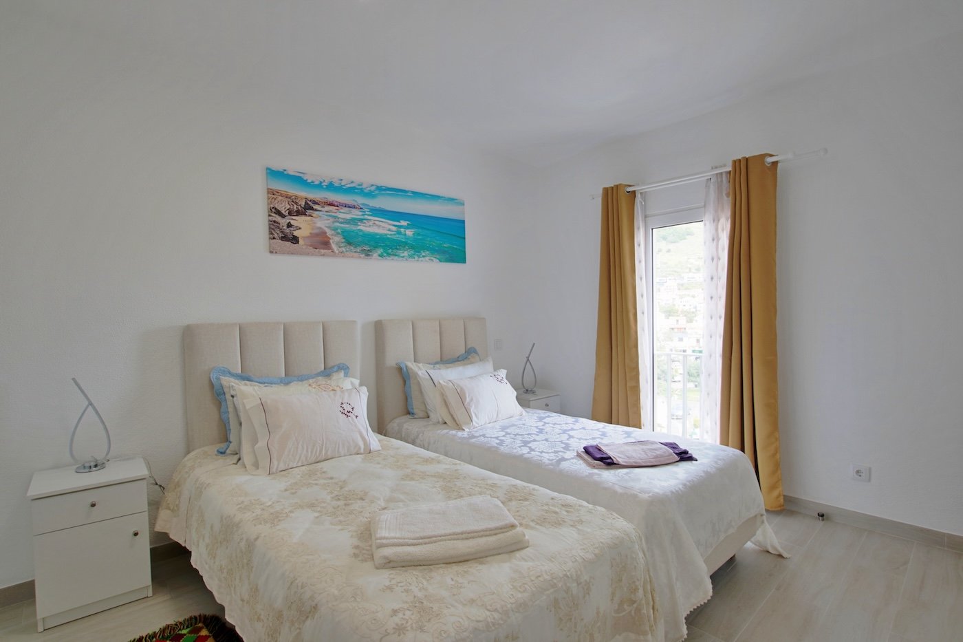 Bedroom with two single beds and window