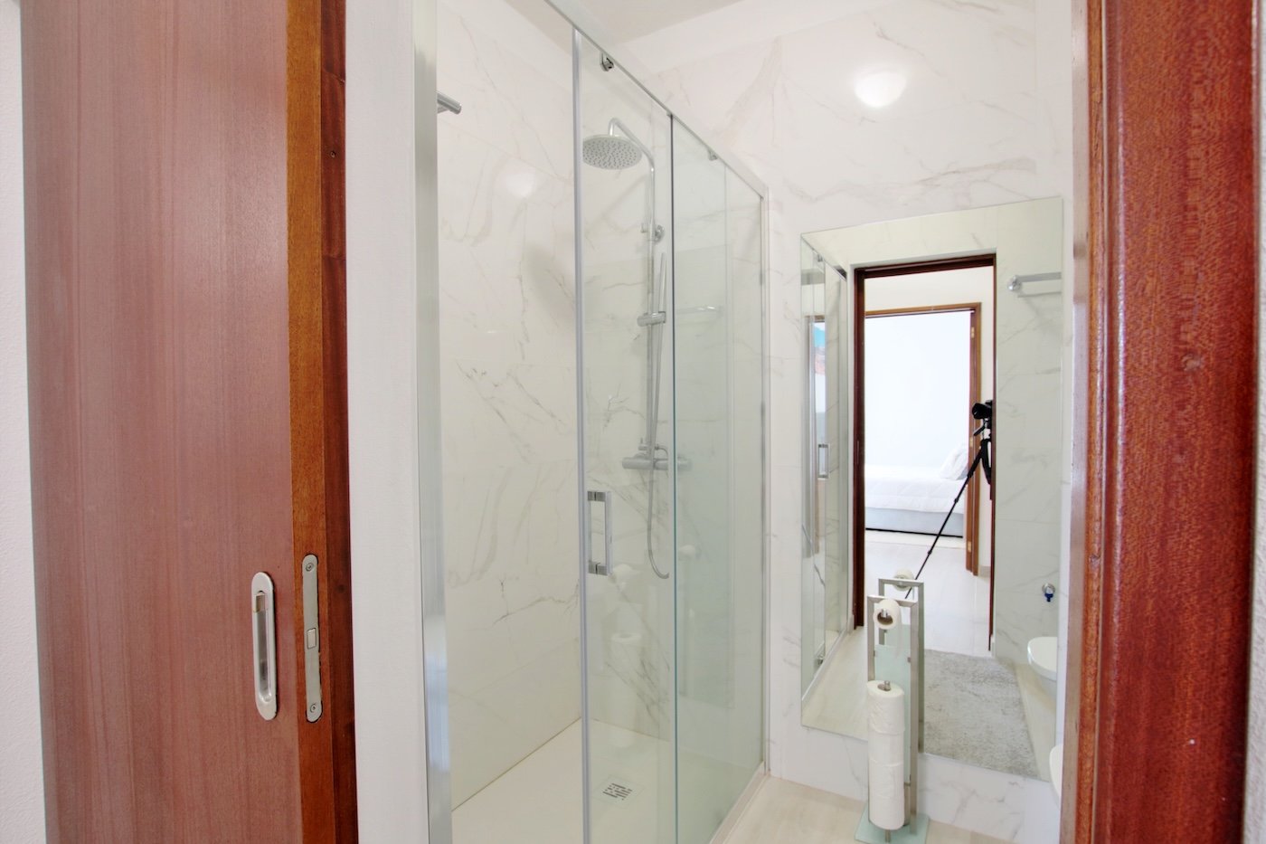 Entrance to bathroom with shower and mirror