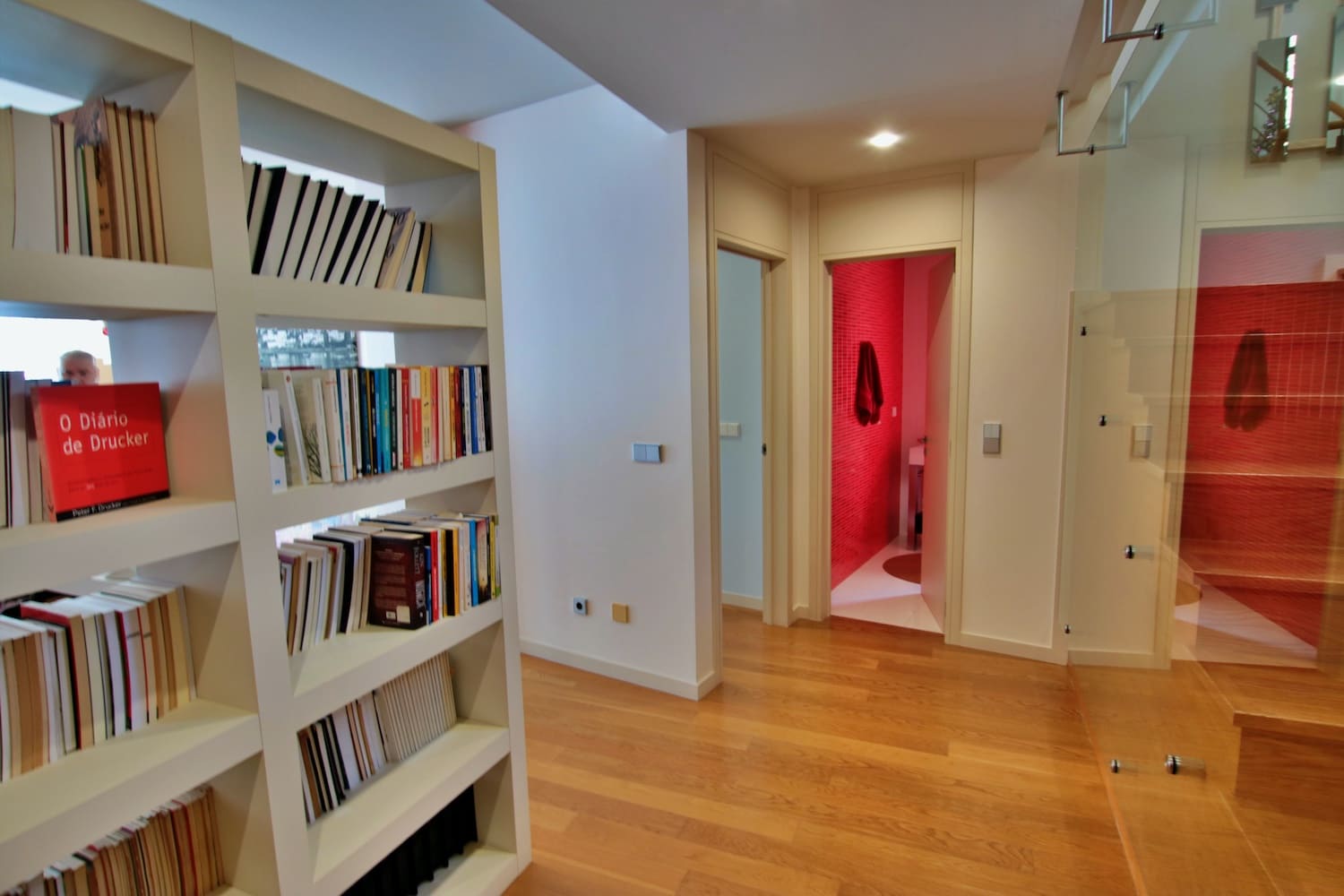 LOUNGE HALLWAY with bookshelf and entrance to a room