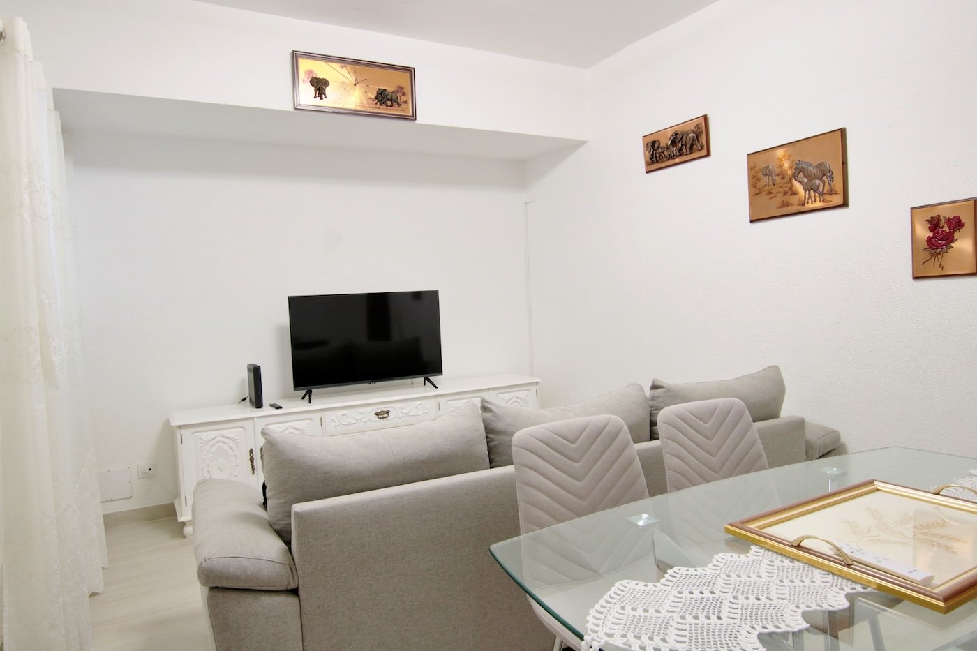 Living room with table, chairs, sofa and tv