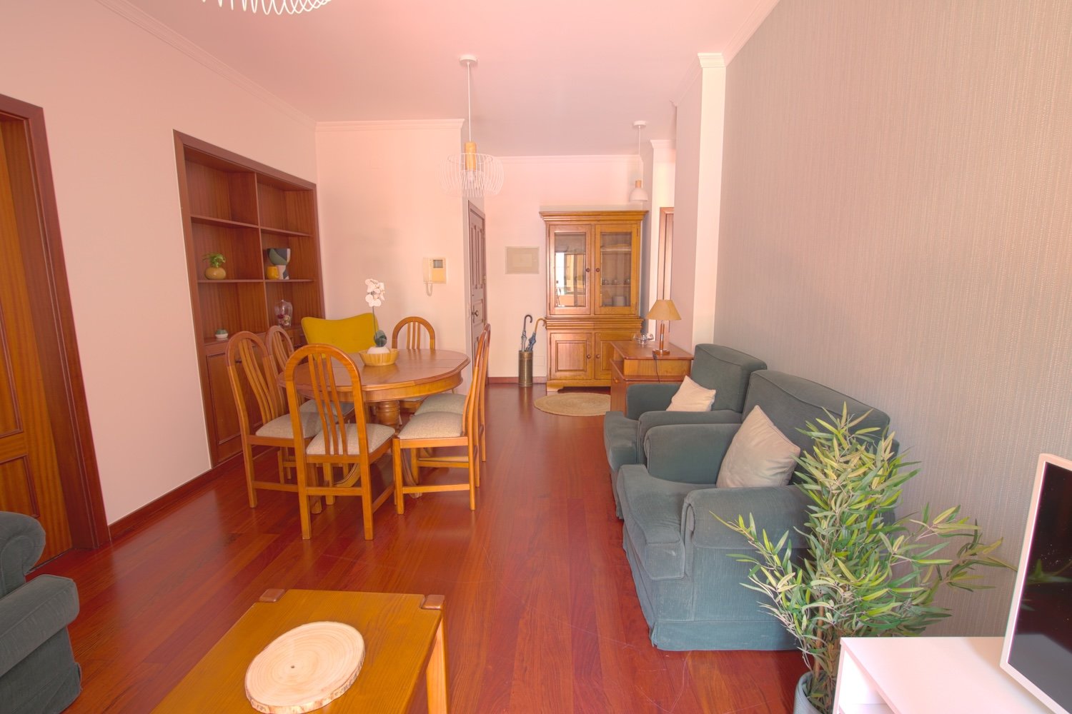 Lounge with two armchairs, tv stand, dining table,its chairs, and a shelf