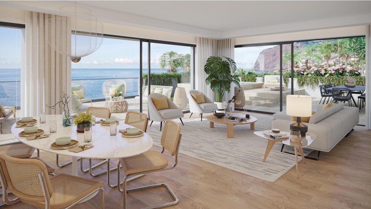 Livingroom with dining table, sofa and sea views