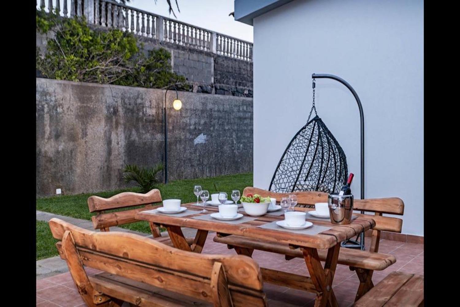 Patio area with a table and benches 