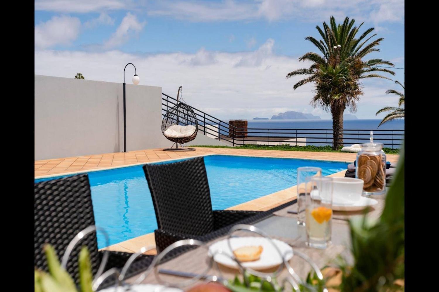 Swimming pool area with tables and chairs