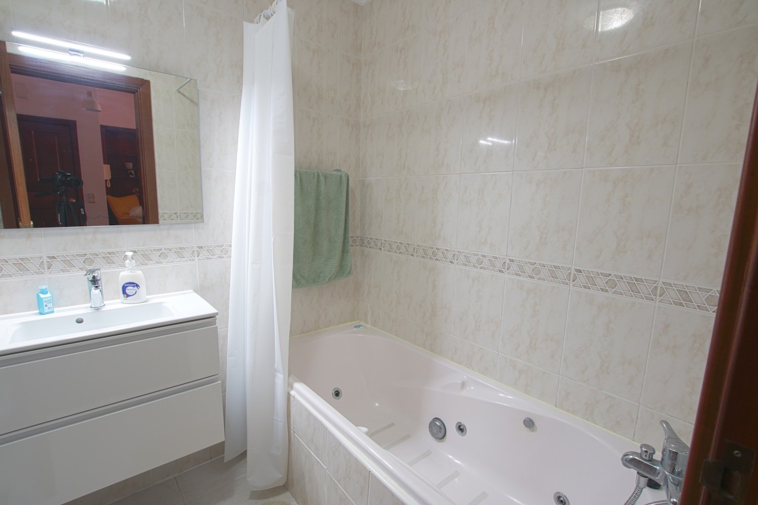 The bathroom with a bathtub and a basin