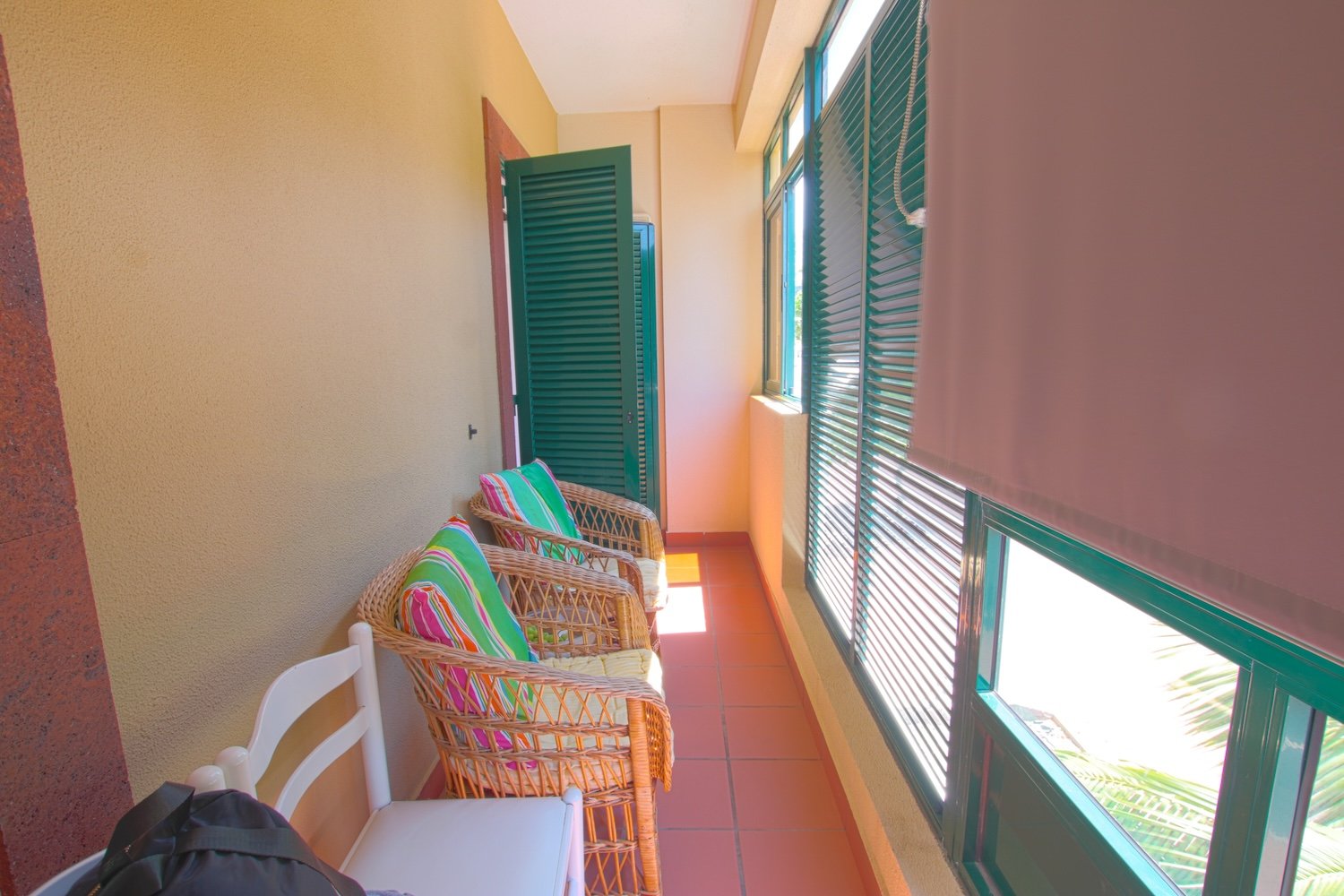 The main veranda with two armchairs and an aditional chair