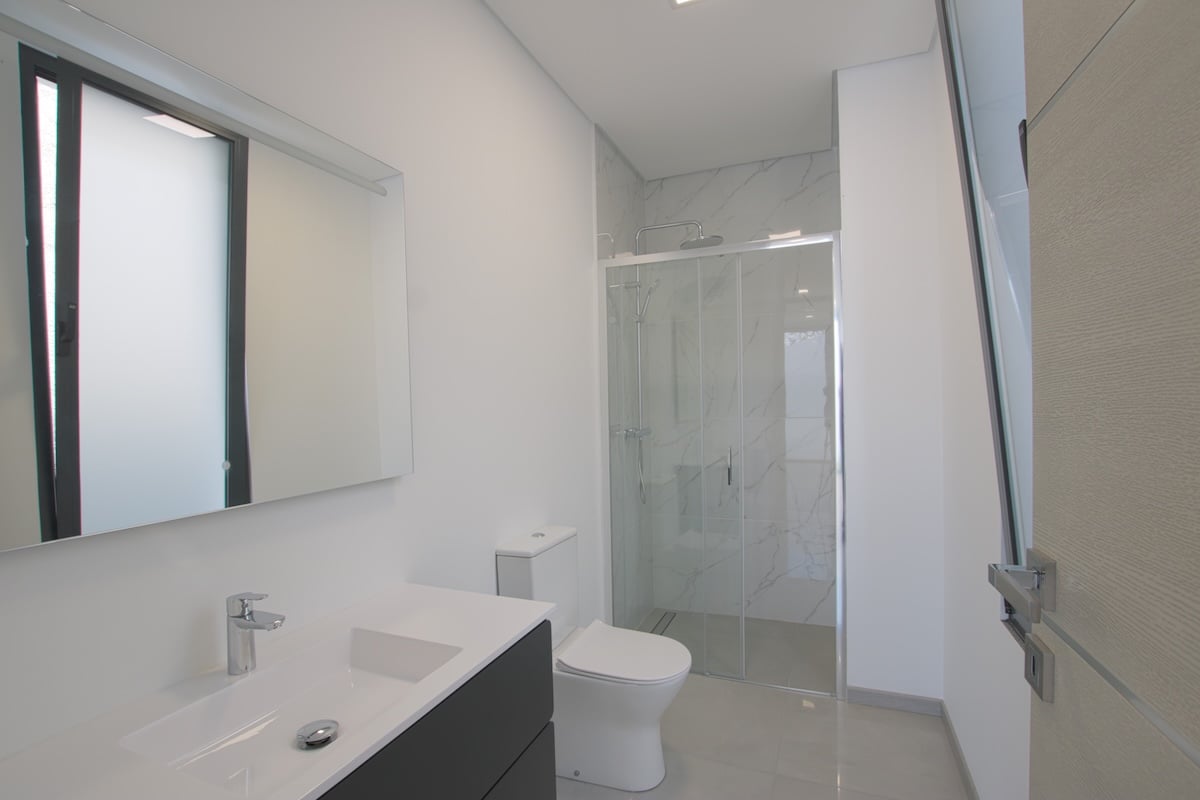 Bathroom with hand basin toilet seat and shower