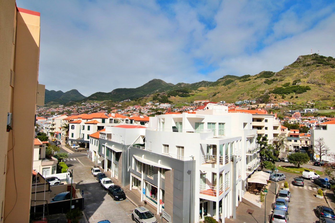 View from bedroom window with two roads and surrounding buildings