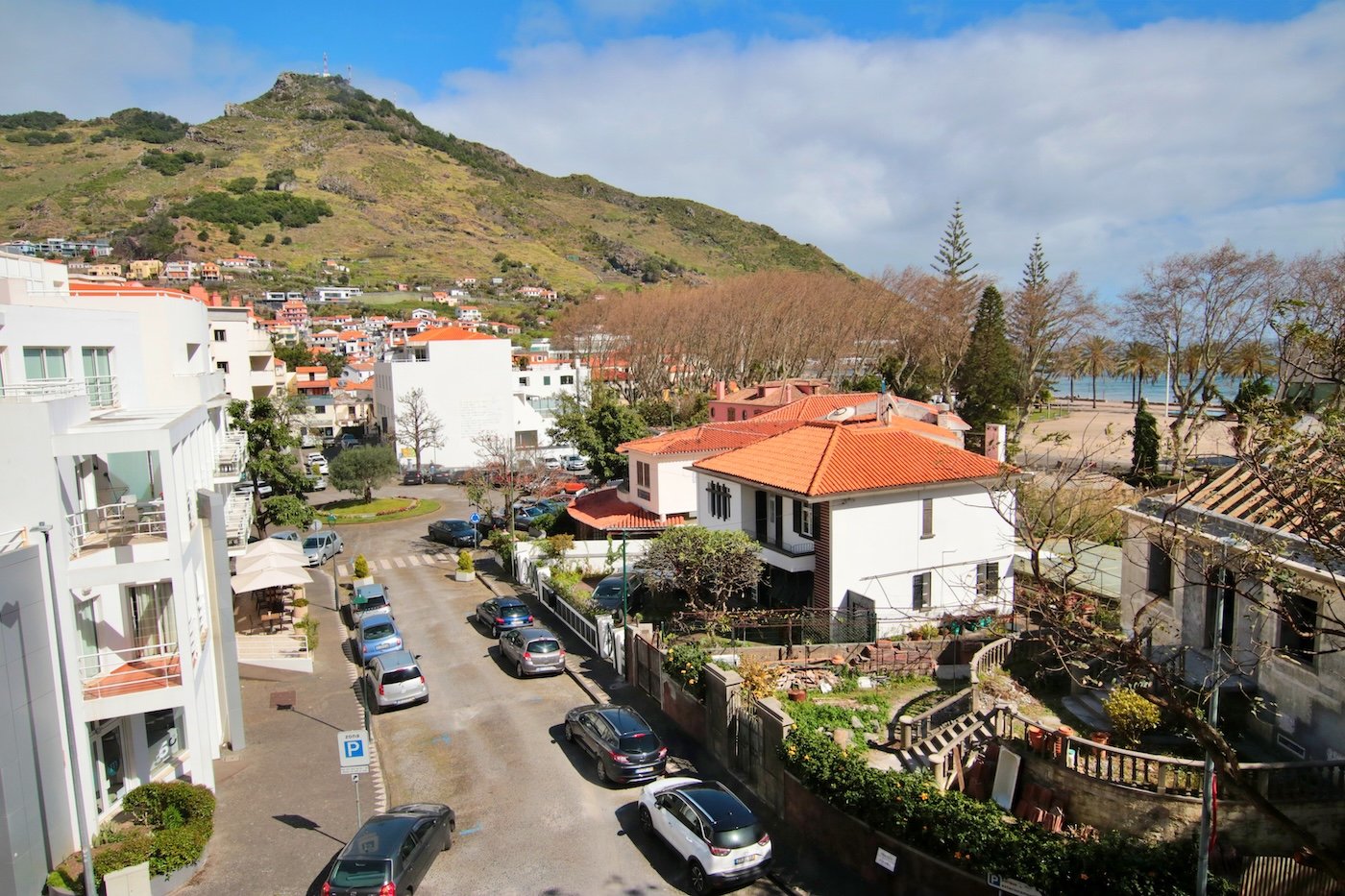 View from the bedroom window with a road leading to a roundabout and the surrounding buildings
