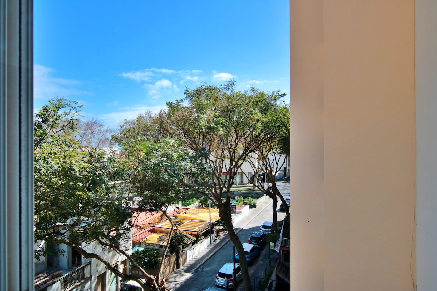 View from the kitchen window, with trees, road and restaurant