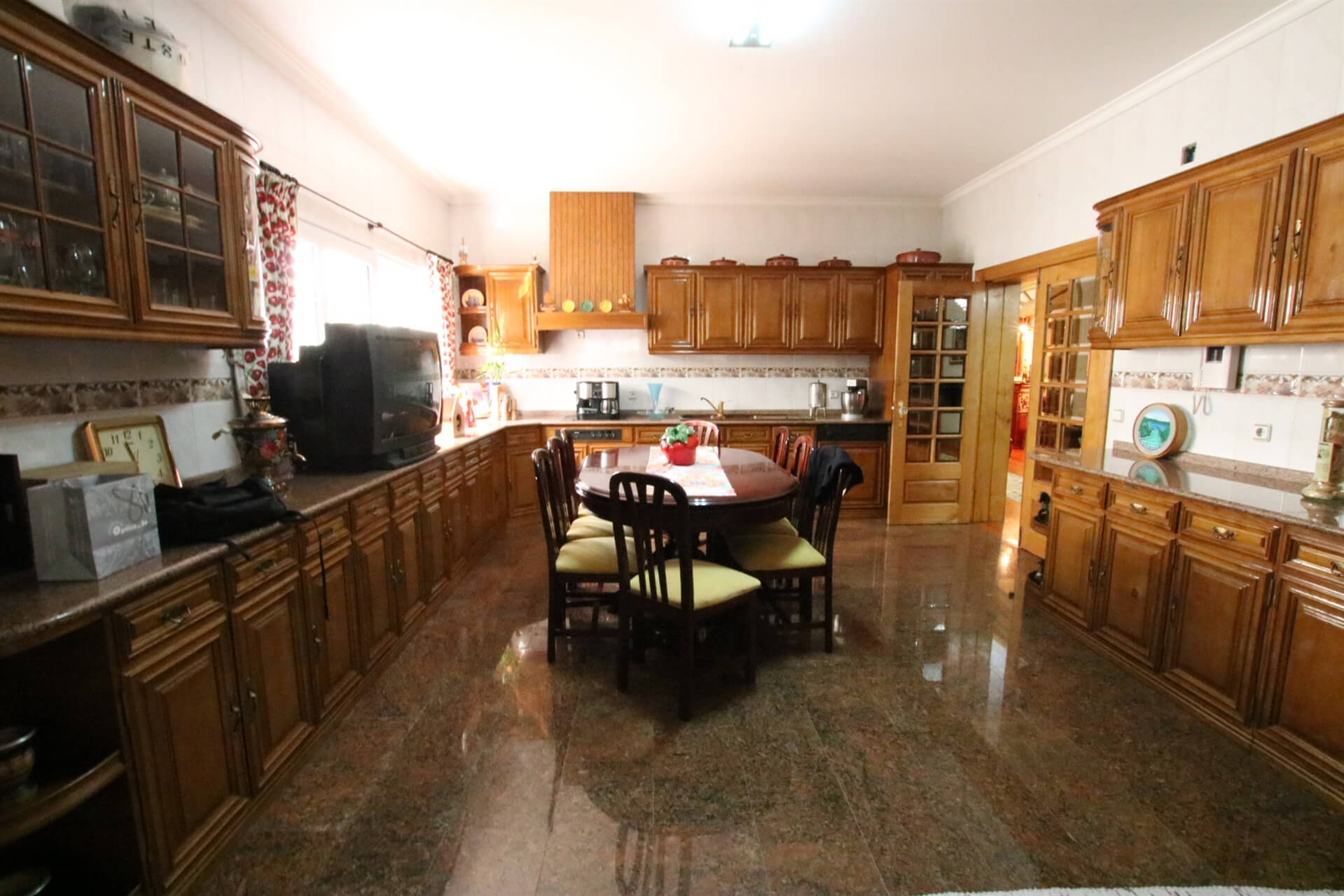 Large kitchen with table in the middle